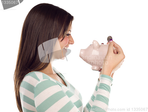 Image of Ethnic Female Putting Coin Into Piggy Bank on White