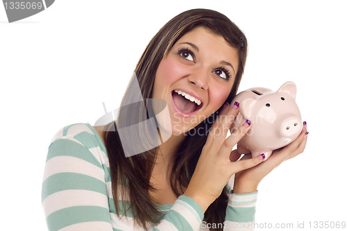 Image of Ethnic Female Daydreaming and Holding Pink Piggy Bank