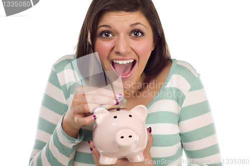 Image of Ethnic Female Putting Coin Into Piggy Bank on White
