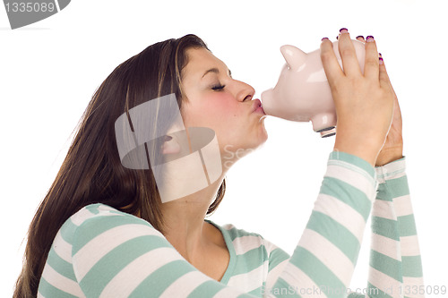 Image of Ethnic Female Kissing Pink Piggy Bank on White