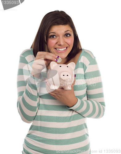 Image of Ethnic Female Putting Coin Into Piggy Bank on White