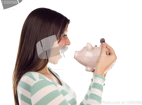 Image of Ethnic Female Putting Coin Into Piggy Bank on White