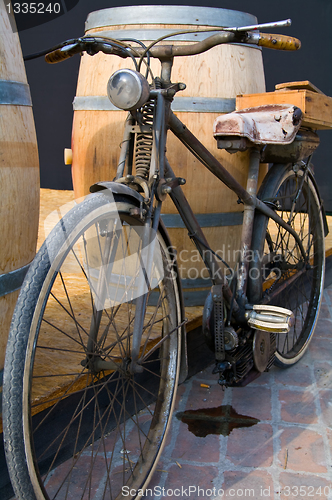 Image of Old moped standing leaking petrol on the ground