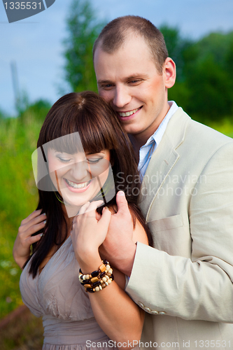 Image of happy enamoured couple embracing