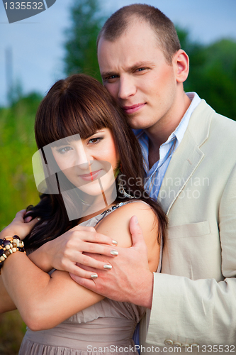 Image of happy enamoured couple embracing