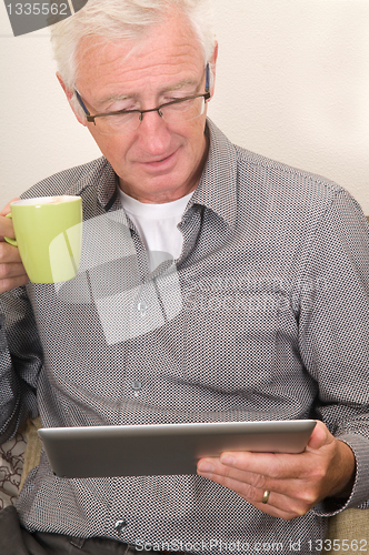 Image of Senior working on a tablet pc