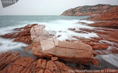 Image of rocky sea coast and blurred water 