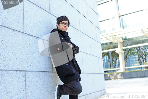 Image of asia man relax in the park in the city 