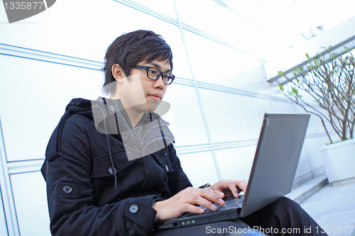 Image of man using computer outdoor 