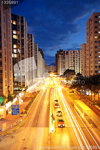 Image of modern urban city at night with freeway traffic