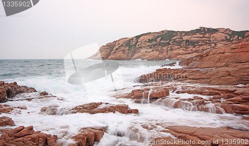 Image of rocky sea coast and blurred water 