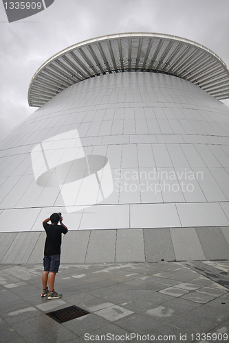 Image of man takeing photo of modern building