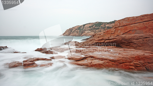 Image of rocky sea coast and blurred water 