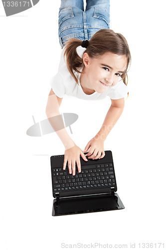 Image of Little student girl with a laptop