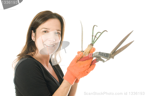Image of middle age  woman gardener with  cultivator plant tools