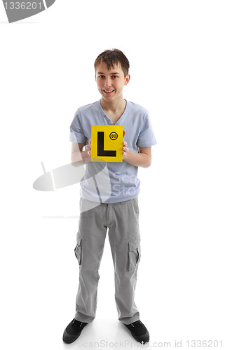 Image of Teen boy holding L learner plates