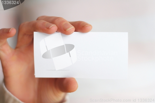 Image of hand and blank paper with copyspace