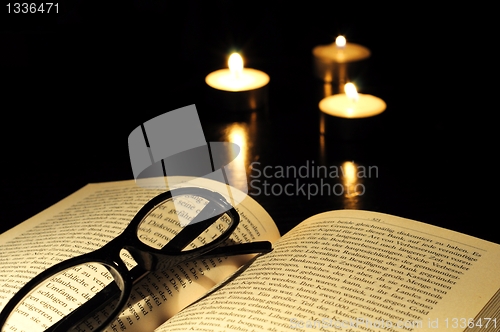 Image of book candle and glasses