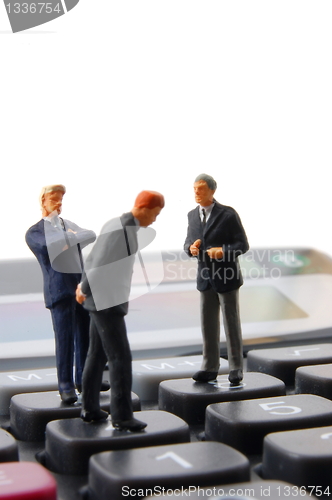 Image of business people on calculator isolated