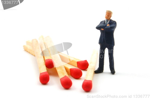 Image of business man and matches on white