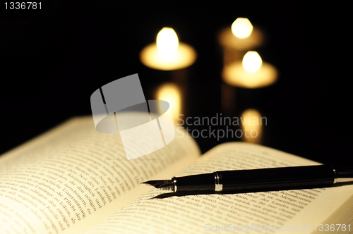 Image of book candle and glasses