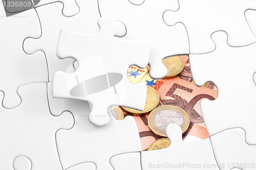 Image of puzzle and money