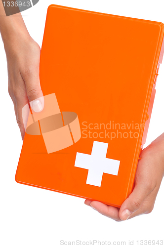 Image of Hands of young woman holding first aid kit