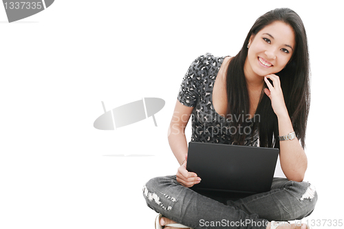 Image of attractive young female sitting on the floor using laptop 