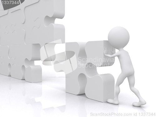 Image of business teamwork - business person building a puzzle which was 