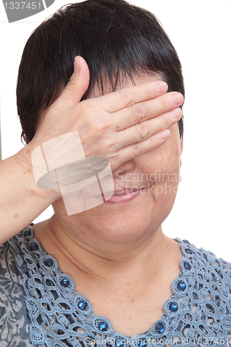 Image of asia woman blinding her eyes by hand