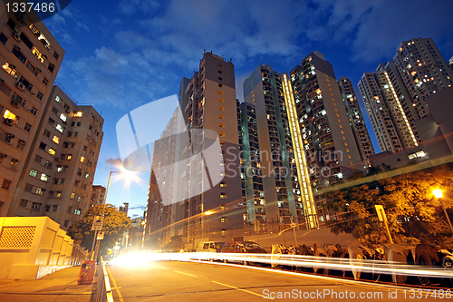 Image of modern urban city at night with freeway traffic