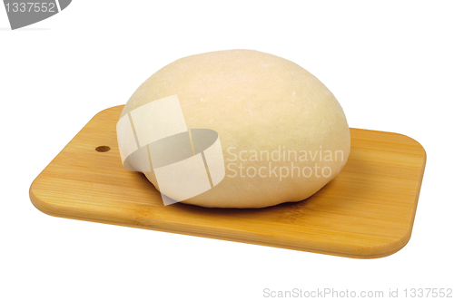 Image of Flour the dough on a wooden board