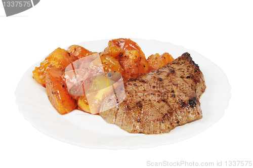 Image of Plate with a beef steak and roasted tomatoes