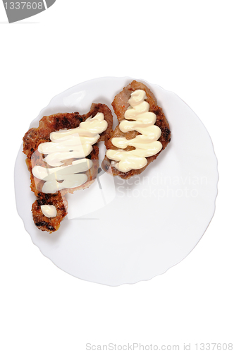 Image of Grilled meat  with  mayonnaise  on a plate.