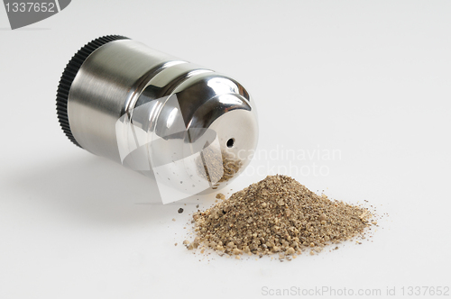 Image of Pepper shaker and spilled pepper