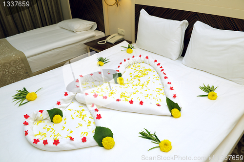 Image of Bed Suite decorated with flowers and towels.