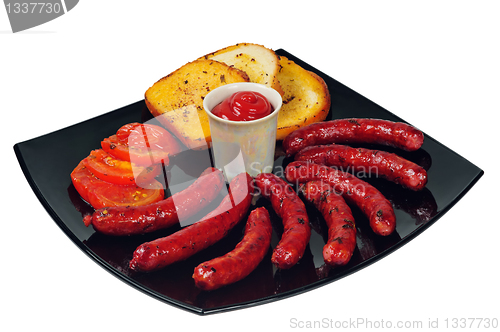 Image of Plate with grilled sausages and ketchup