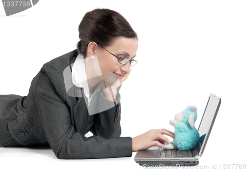 Image of Young business woman looking at a child's toy