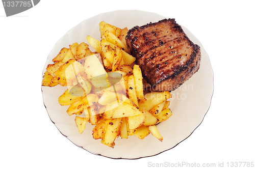 Image of Grilled meat and  fried  potatoes  on a plate