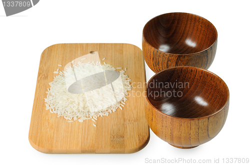 Image of Wooden bowls for rice. Handful of rice