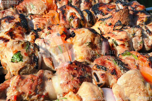 Image of Kebabs, threaded on a skewer and grill.