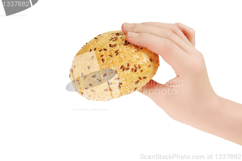 Image of Bun, topped with sesame seeds in hand