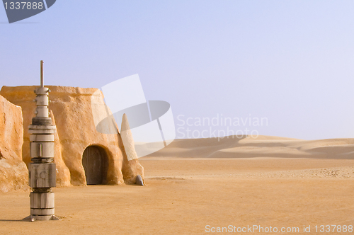 Image of Tataouine scenery on a background of sand dunes.