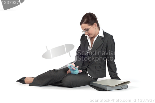 Image of Young business woman playing with a toy