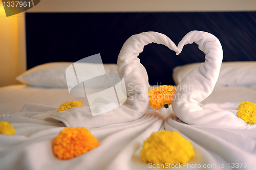 Image of Bed Suite decorated with flowers and towels.