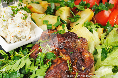 Image of Grilled meat and potatoes