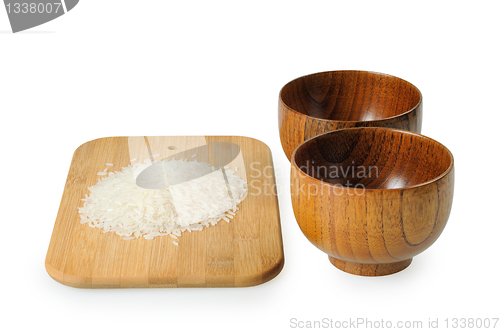 Image of Wooden bowls for rice. Handful of rice