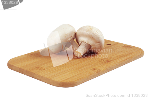 Image of Mushrooms on a wooden board.