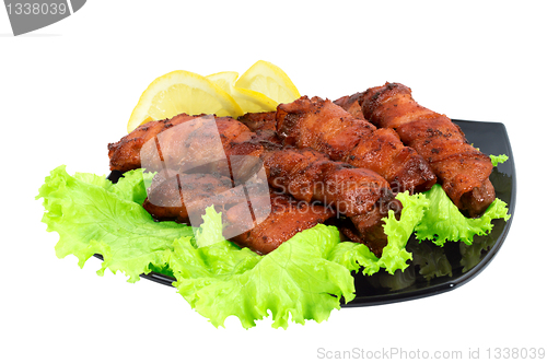 Image of Roasted meat, wrapped in bacon on the dish