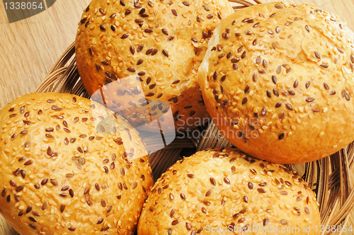 Image of Bun, topped with sesame seeds in a basket